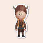 A sticker of a girl dressed as a shieldmaiden in Viking attire, complete with a brown helmet adorned with horns.