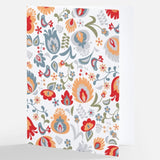 A notecard featuring a multicolored Nordic floral pattern with a mix of flowers and leaves in red, blue, orange, and grey tones on a white background, from The Uff Da Sisters.