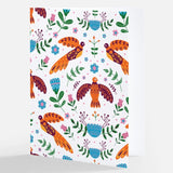 A white notecard adorned with a colorful Nordic-inspired pattern featuring stylized orange birds and a variety of floral elements, from The Uff Da Sisters.