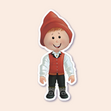 A sticker of a smiling boy dressed in traditional Nordic attire, including a red pointed hat and black boots with decorative buckles.