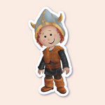 A sticker of a boy dressed as a Viking, complete with a horned helmet and a brown fur-trimmed tunic, smiling warmly.