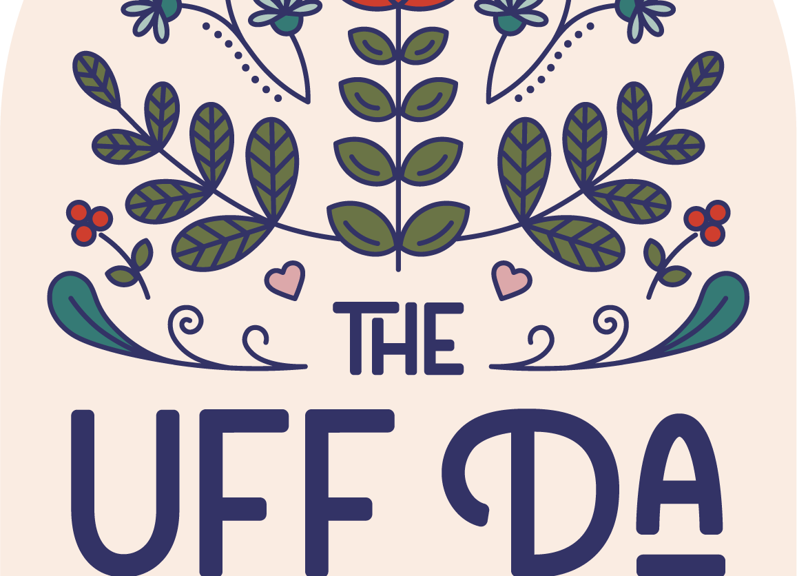 The Uff Da Sisters' badge logo that features a cream colored arch that contains Scandinavian-inspired floral illustrations and the brand name in navy blue text.