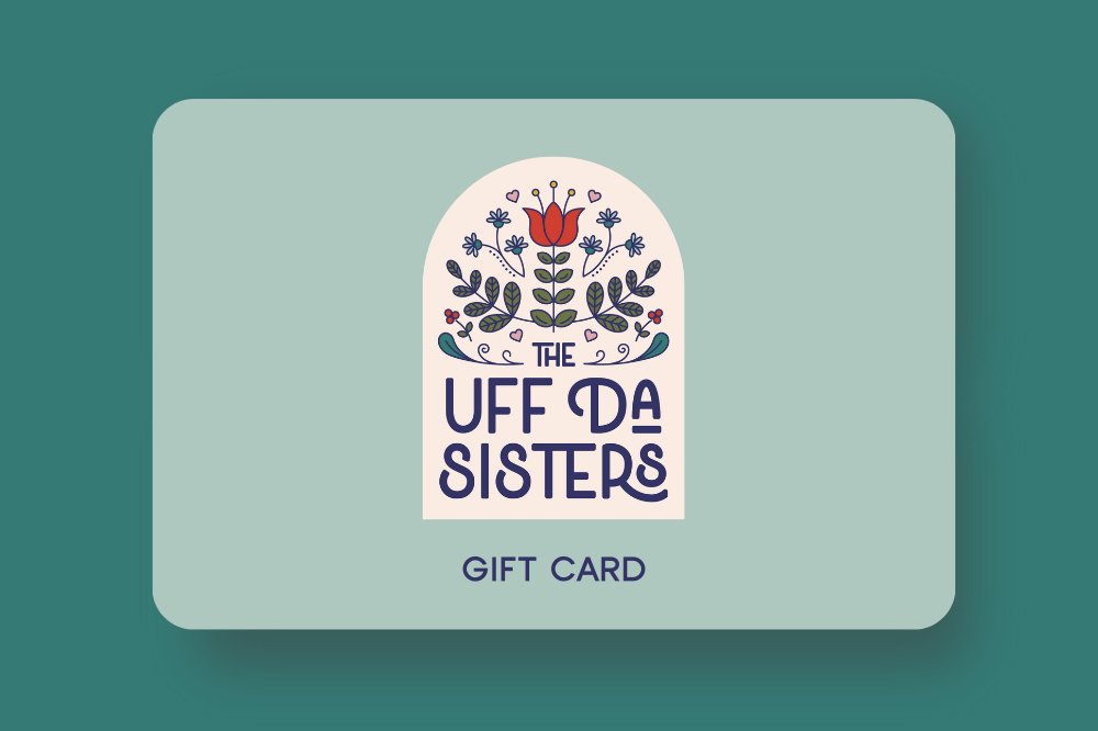 Image of The Uff Da Sisters gift card that includes their main arch shaped badge logo on a pale aqua gift card.