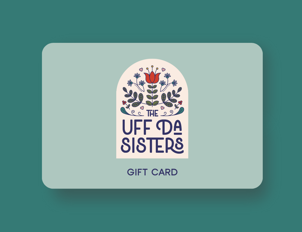 Image of The Uff Da Sisters gift card that includes their main arch shaped badge logo on a pale aqua gift card.